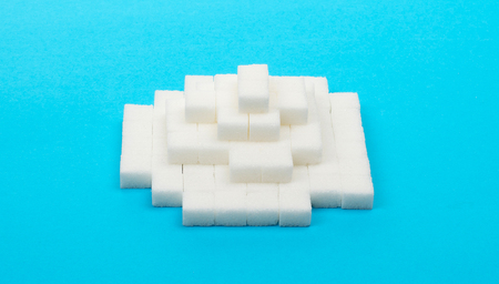 Pile of sugar cubes, isolated on blueの写真素材