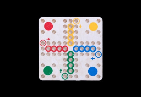 Vintage game of ludo, isolated on black backgroundの写真素材