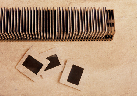 Retro blank slide photo framework against an old paper, grunge backgroundの写真素材