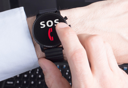 Black smartwatch isolated on a black background, SOSの写真素材