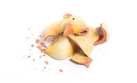 Broken statue of a duckling, isolated on whiteの写真素材