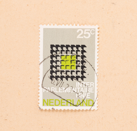 THE NETHERLANDS 1970: A stamp printed in the Netherlands shows a logo of the Inter Parlementaire Unie, circa 1970のeditorial素材
