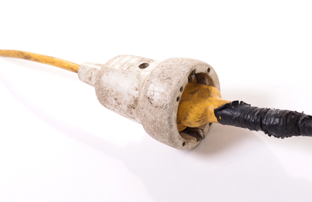 Extension cord, old and probably not safe anymore - Isolated on whiteの写真素材