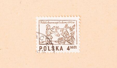 POLAND - CIRCA 1970: A stamp printed in Poland shows a beekeeper with his hives, circa 1970の写真素材
