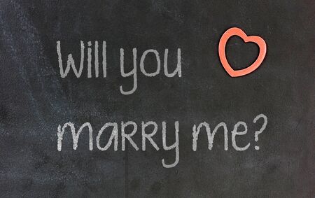 Blackboard with small red heart in the corner - Will you marry me?の写真素材