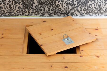 Wooden square old hatchway in the cellar in the floor of wooden planksの写真素材