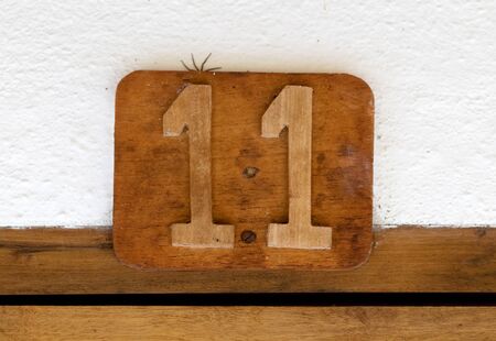 Spider hiding behind a sign - Room number 11の写真素材