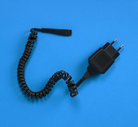 Black charger (220v) isolated on a blue background