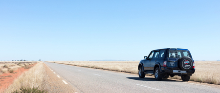 Madagascar on july 30, 2019 - A black car on a deserted road on Madagascar.