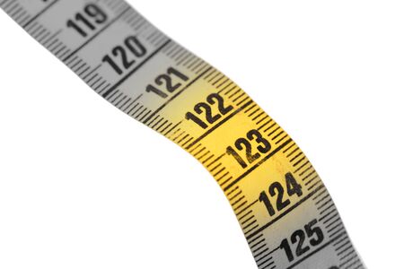 Close-up of a yellow measuring tape isolated on white - 123 - Selective focusの写真素材