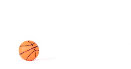 Single small rubber toy in form of basketball, isolated on white backgroundの写真素材