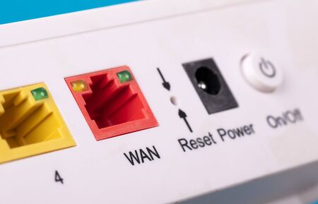 Desktop Home ADSL modem on a blue background back view, selective focus