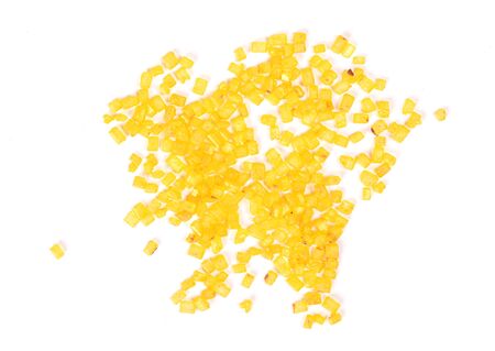 Gold colored sugar, isolated on a white backgroundの写真素材