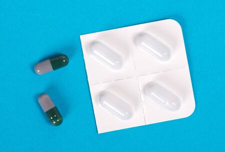Pills isolated on blue background - Medicine conceptの写真素材