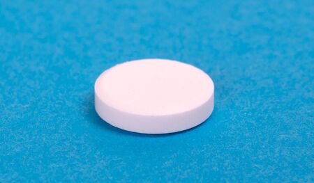 Pill isolated on blue background - Medicine concept