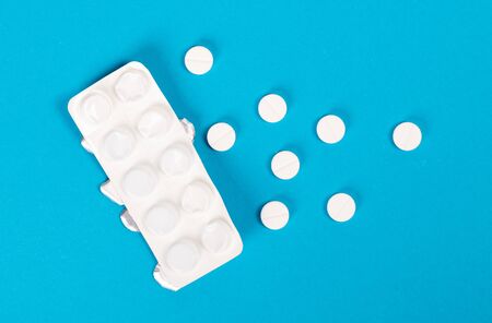 Pills isolated on blue background - Medicine conceptの写真素材