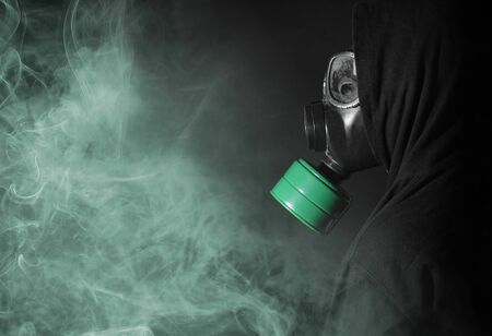 Man in a gas mask in the smoke, green smokeの写真素材
