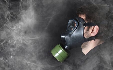 Man in a gas mask in the smoke, blackの写真素材