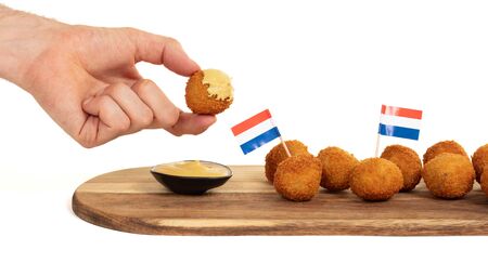 Dutch traditional snack bitterbal in a hand, isolatedの写真素材