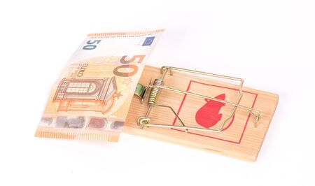 Money on the mousetrap, isolated on whiteの写真素材