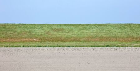 Sideview of a large dyke in the Netherlands, Frieslandの写真素材