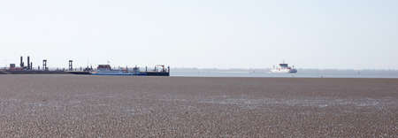 Ameland, the Netherlands on may 30, 2020: The mud flats on the waddensea with the arrival of the ferryのeditorial素材