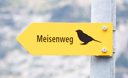 'Road of the tits' written in german (Meisenweg), yellow sign, selective focus