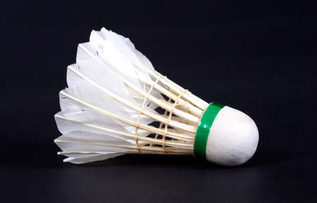 Close-up of very old and dirty shuttlecock badminton, isolated on black
