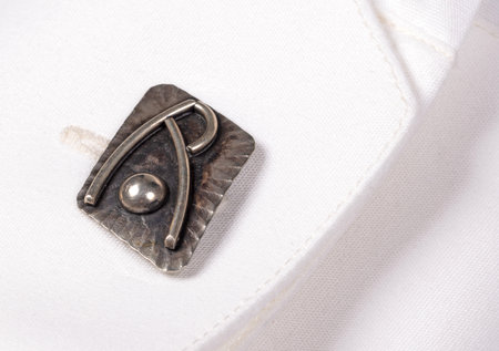 Cufflink on a white shirt, close up view