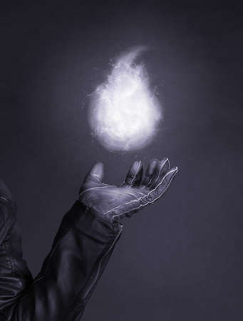 Levitating magic fire flame on a special glove - Concept of magic