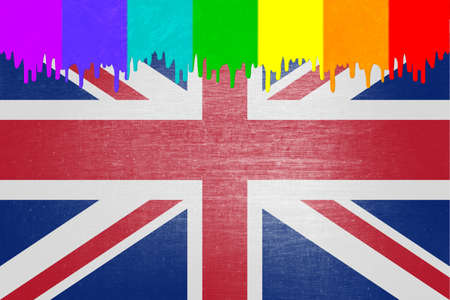 Paint (in the colors of the rainbow flag) is dripping over the national flag of the United Kingdomの写真素材