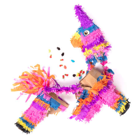 Broken colorful donkey pinata isolated on white backgroundの写真素材
