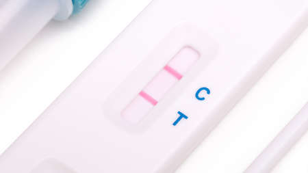 Rapid covid-19 strip test isolated on white - Positive tested