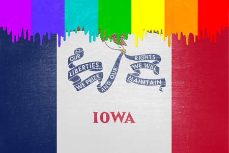 Paint (in the colors of the rainbow flag) is dripping over the state flag of Iowaの写真素材