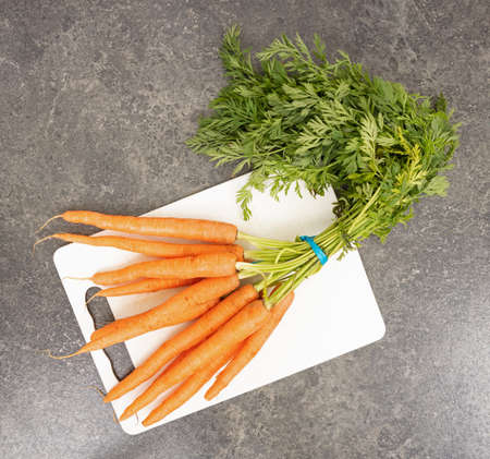 Cutting board with carrots - Concept of foodの写真素材