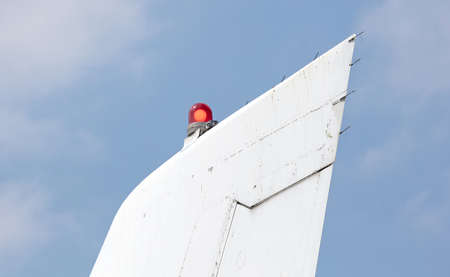 Tail fuselage of an old aircraft, selective focus on the red lightの写真素材