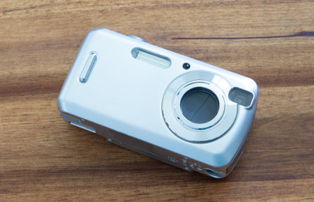 Old digital camera isolated, obsolete and not in use anymore, dusty and dirty