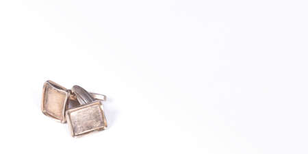 Old gilded cufflinks, isolated on white backgroundの写真素材