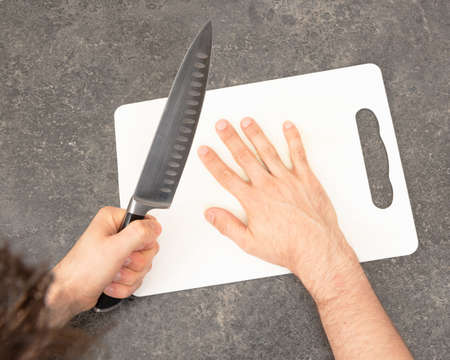 Cutting the fingers with knife - Preparation - Isolated on white