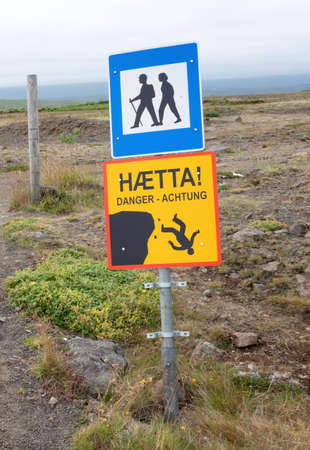 Yellow danger sign in Iceland - Warning of steep cliffsの写真素材