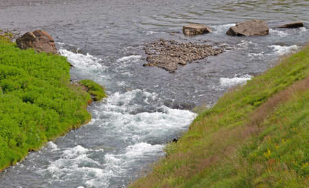 River on Iceland disappearing in the Atlantic Ocean