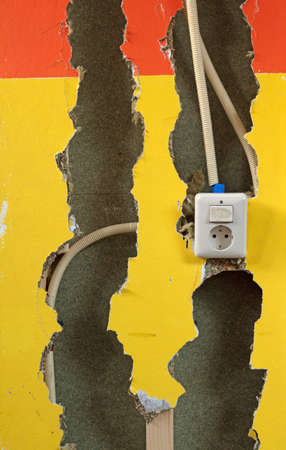 Home renovation concept - Breaking a wooden wall to find the electricity cablesの写真素材