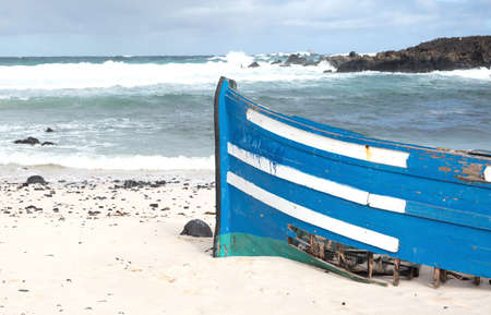 Broken boat on a beach, stranded on an isle