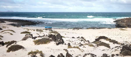 Broken boat on a beach, stranded on an isle