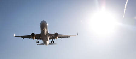 Large airplane preparing the landing with a blue sky
