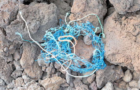 Trash near the ocean, small part of a fishing netの写真素材
