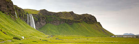 Seljalandfoss, Iceland - July 29, 2021: Seljalandsfoss is one of the best known waterfalls in Iceland. The waterfall drops 60 meters and is part of the Seljalands River that has its origin in the volcano glacier EyjafjallajÃ¶kull.のeditorial素材