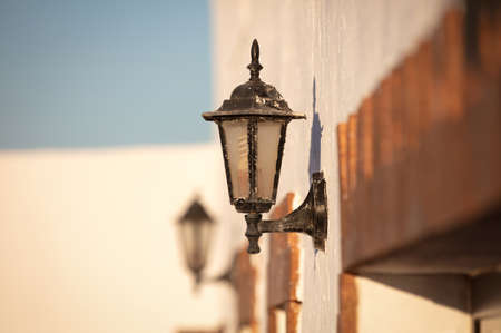 Metal light attached to a wall, outsideの写真素材