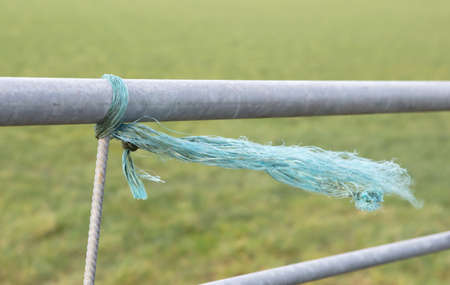 Small rope on a fence, windy day, the Netherlands