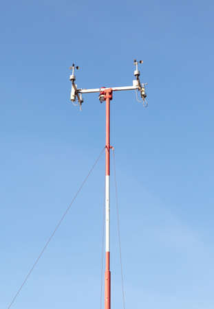 Wind speed sensors against a deep blue sky, measuring wind speed